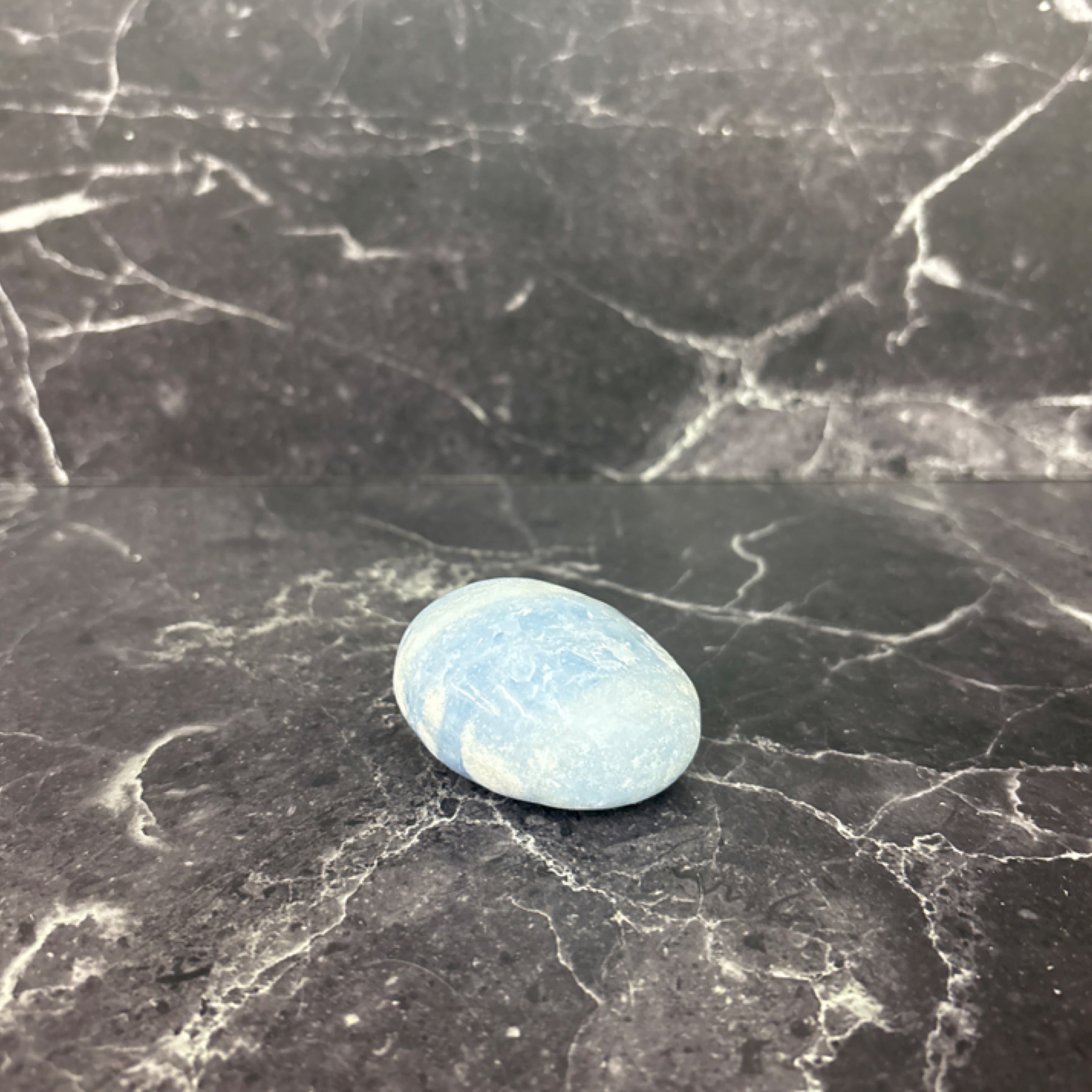 Polished pale blue calcite palm